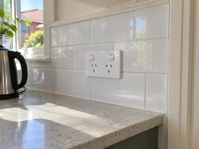 Double power point on a tiled kitchen splashback above a benchtop in Roseville